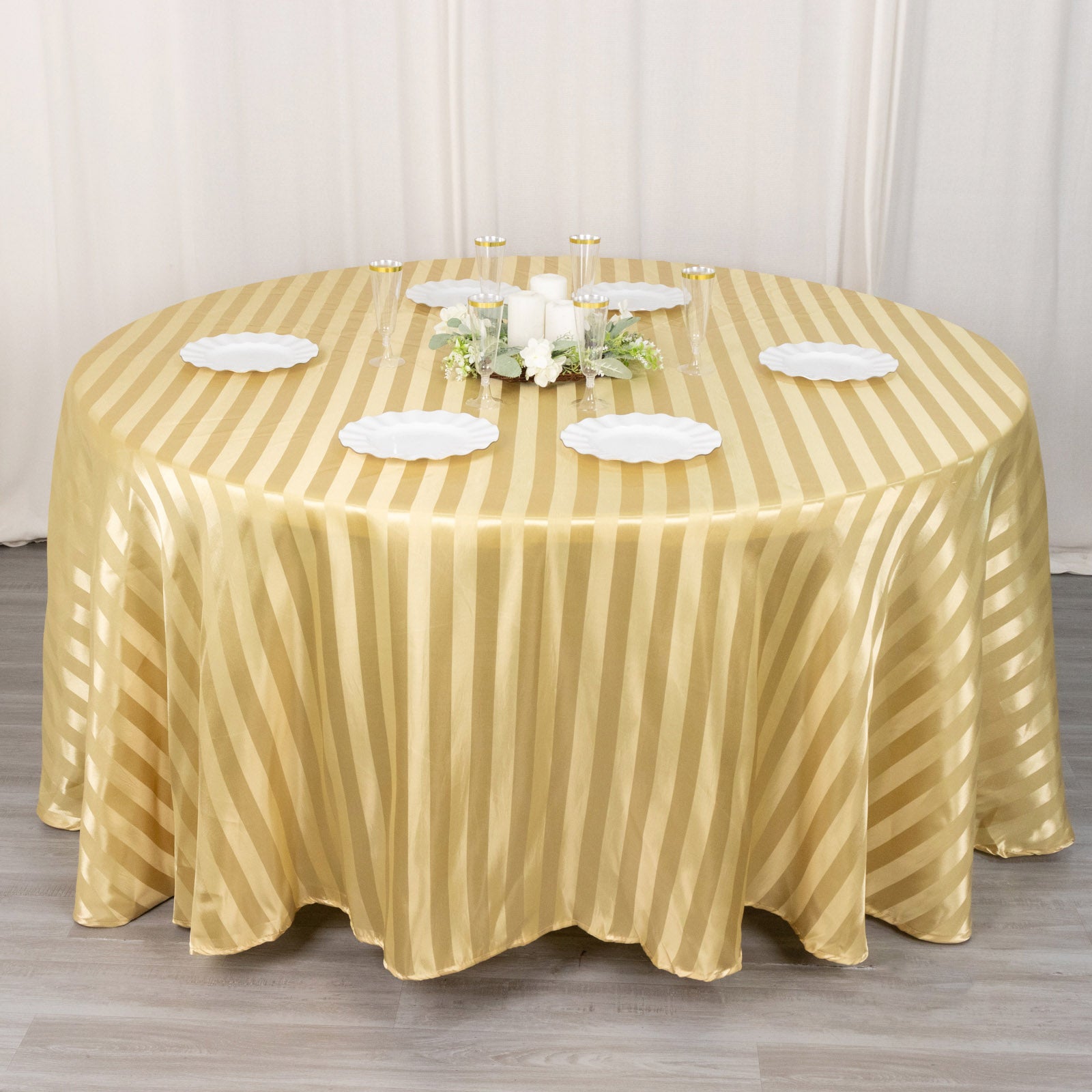 Champagne satin stripe round tablecloth on a dining table.