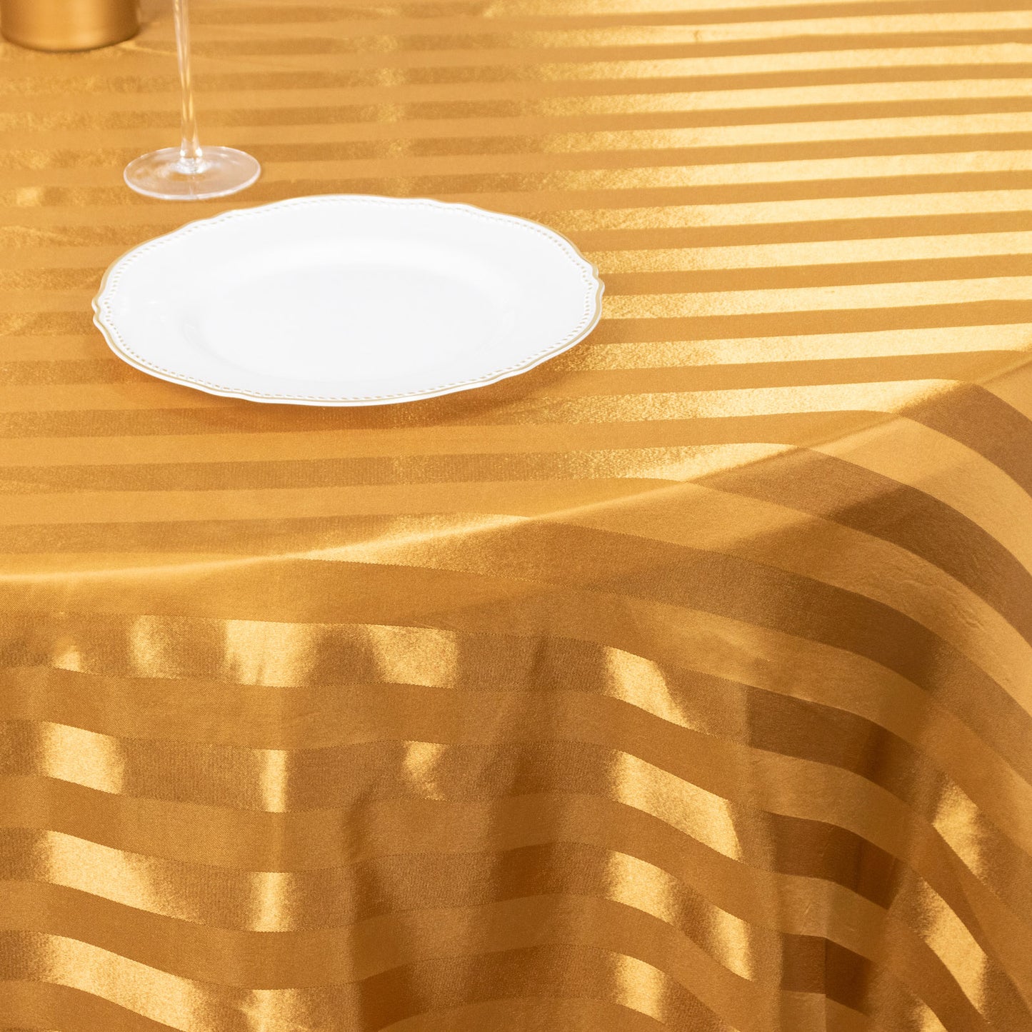 Gold satin stripe round tablecloth.