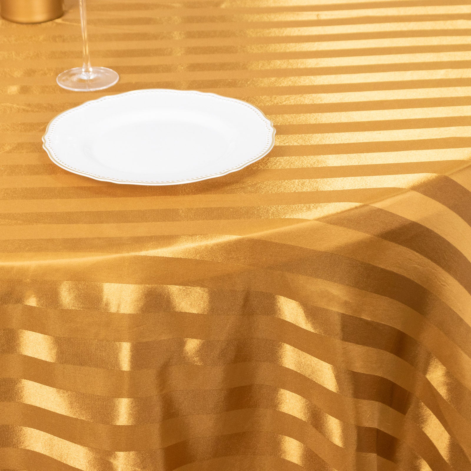 Gold satin stripe round tablecloth.