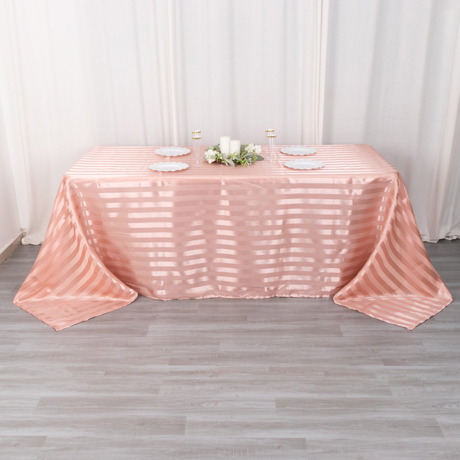 Dusty rose satin stripe tablecloth on a rectangular table.