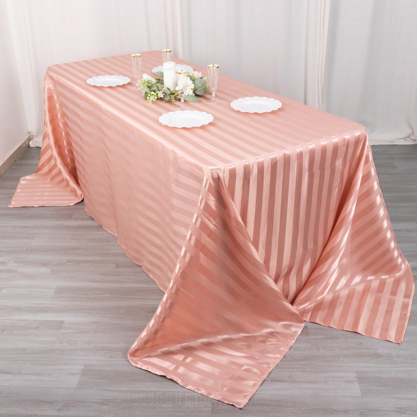 Dusty rose satin stripe seamless tablecloth on a rectangular table.