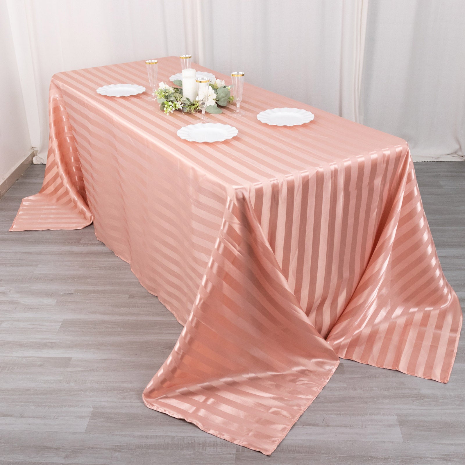 Dusty rose satin stripe seamless tablecloth on a rectangular table.