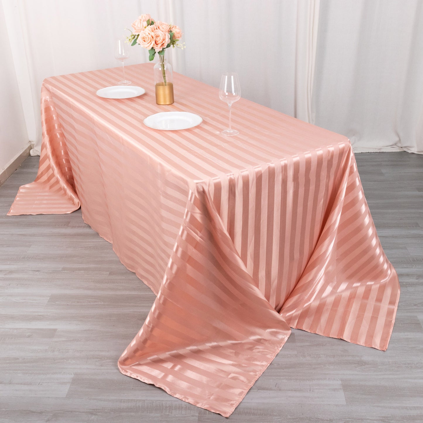 Dusty rose satin stripe tablecloth on a dining table.