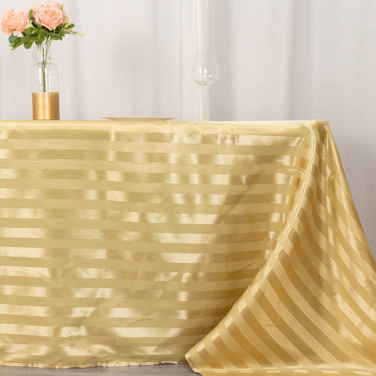 Champagne satin stripe rectangular tablecloth on a table.