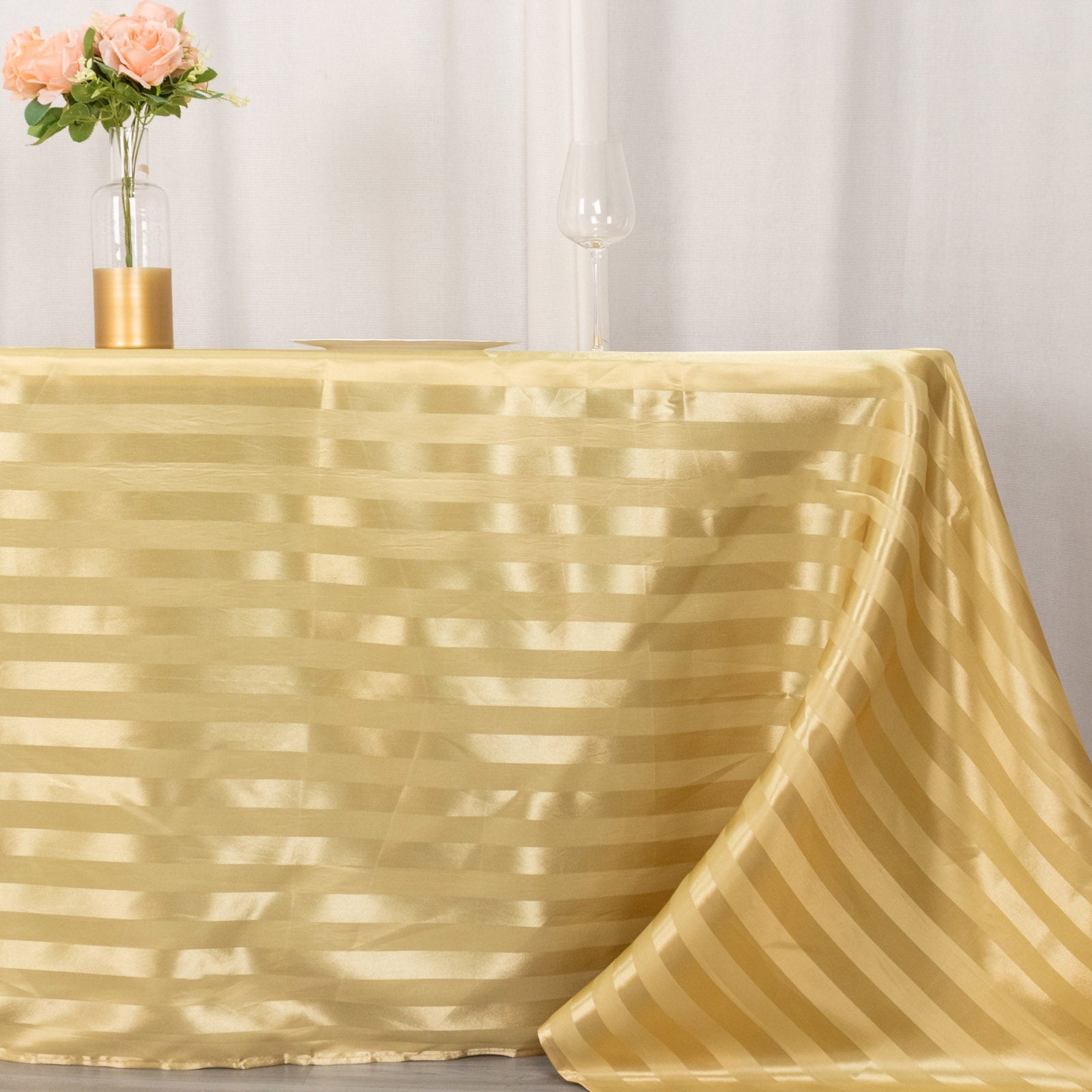 Champagne satin stripe rectangular tablecloth on a table.