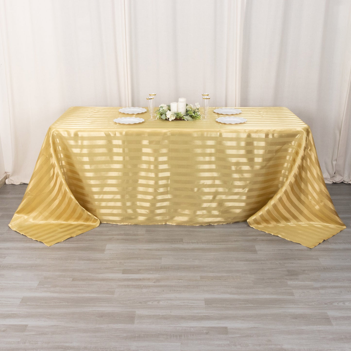Champagne satin stripe rectangular tablecloth on a table.