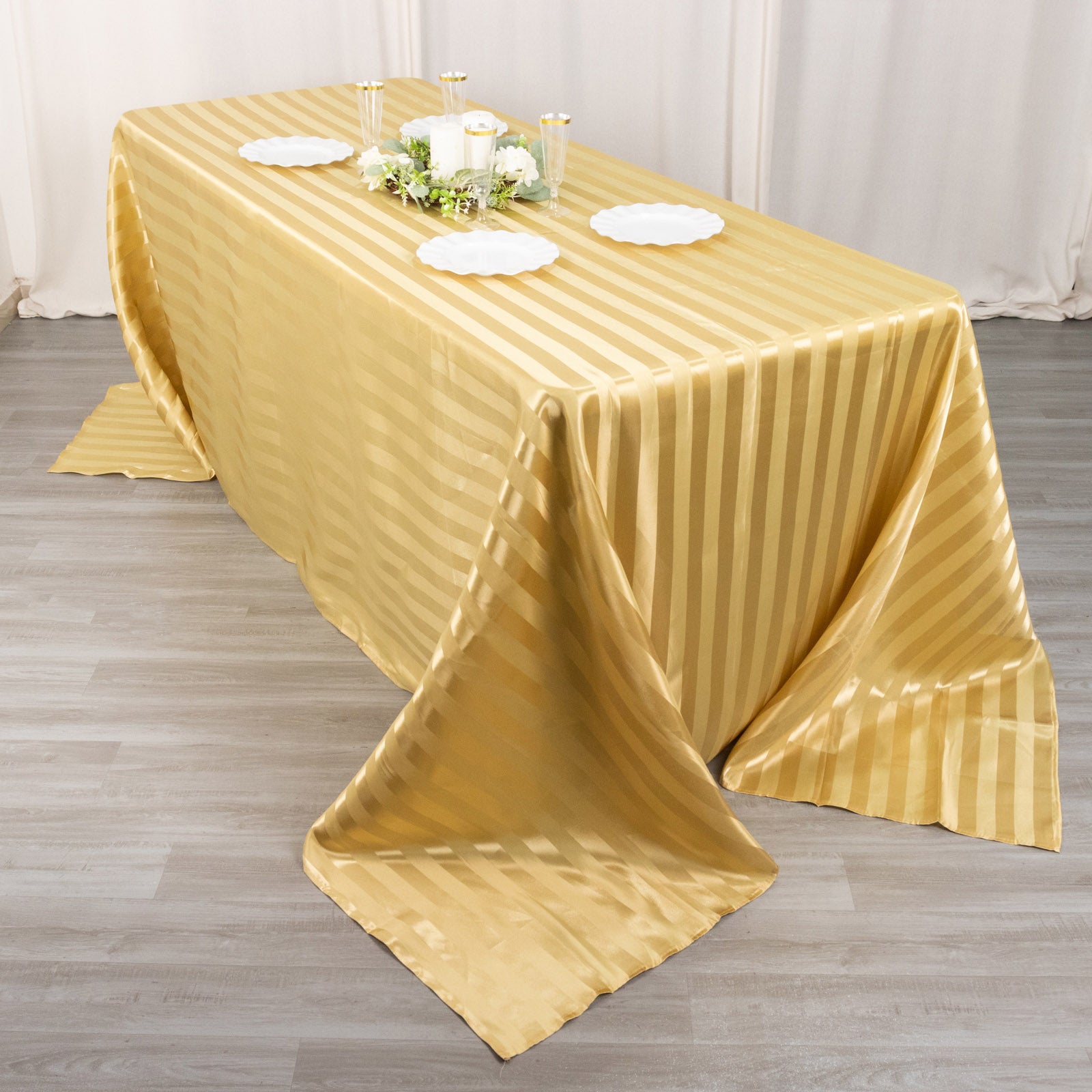 Champagne satin stripe tabletop with elegant decor elements.