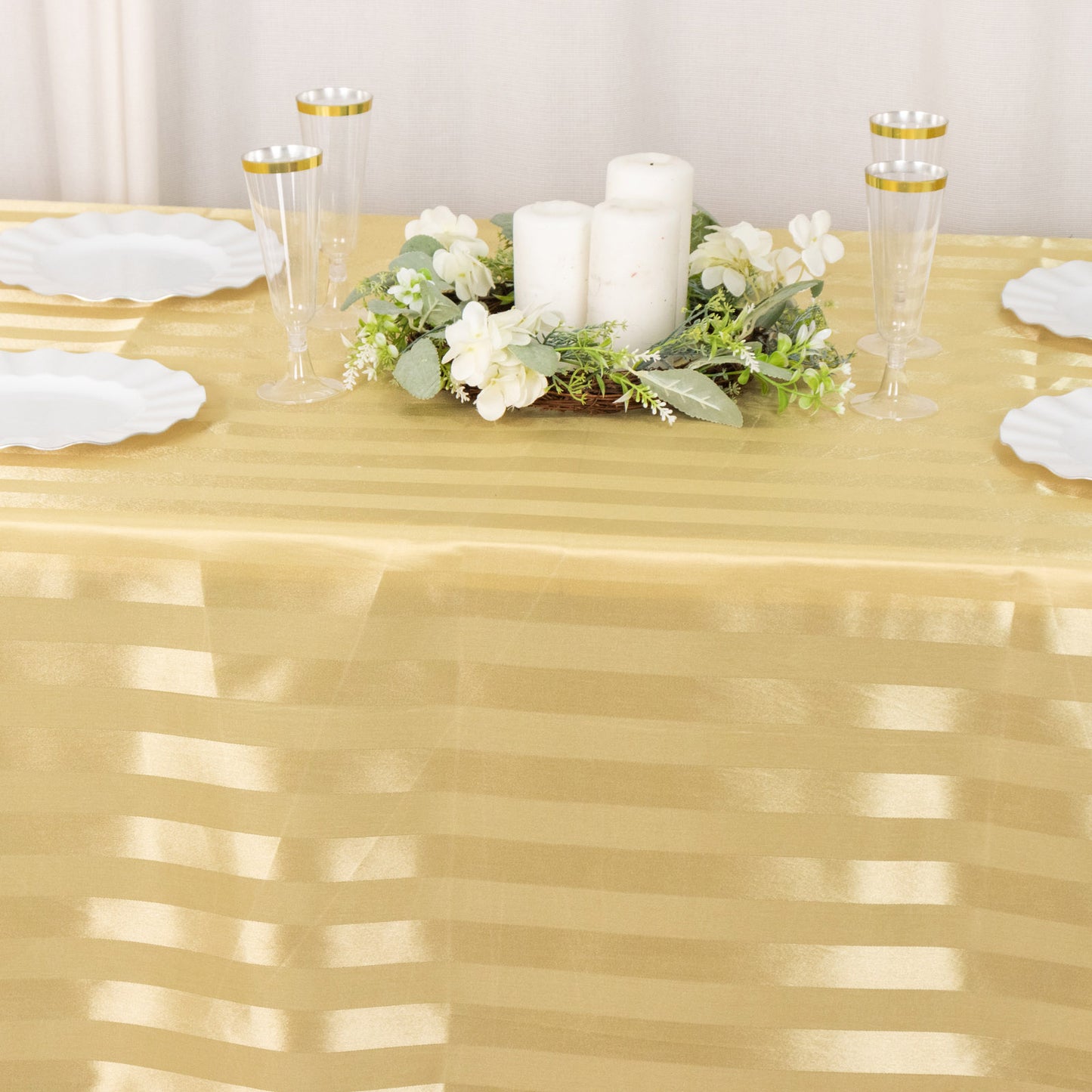 Champagne satin stripe seamless rectangular tablecloth on a table.