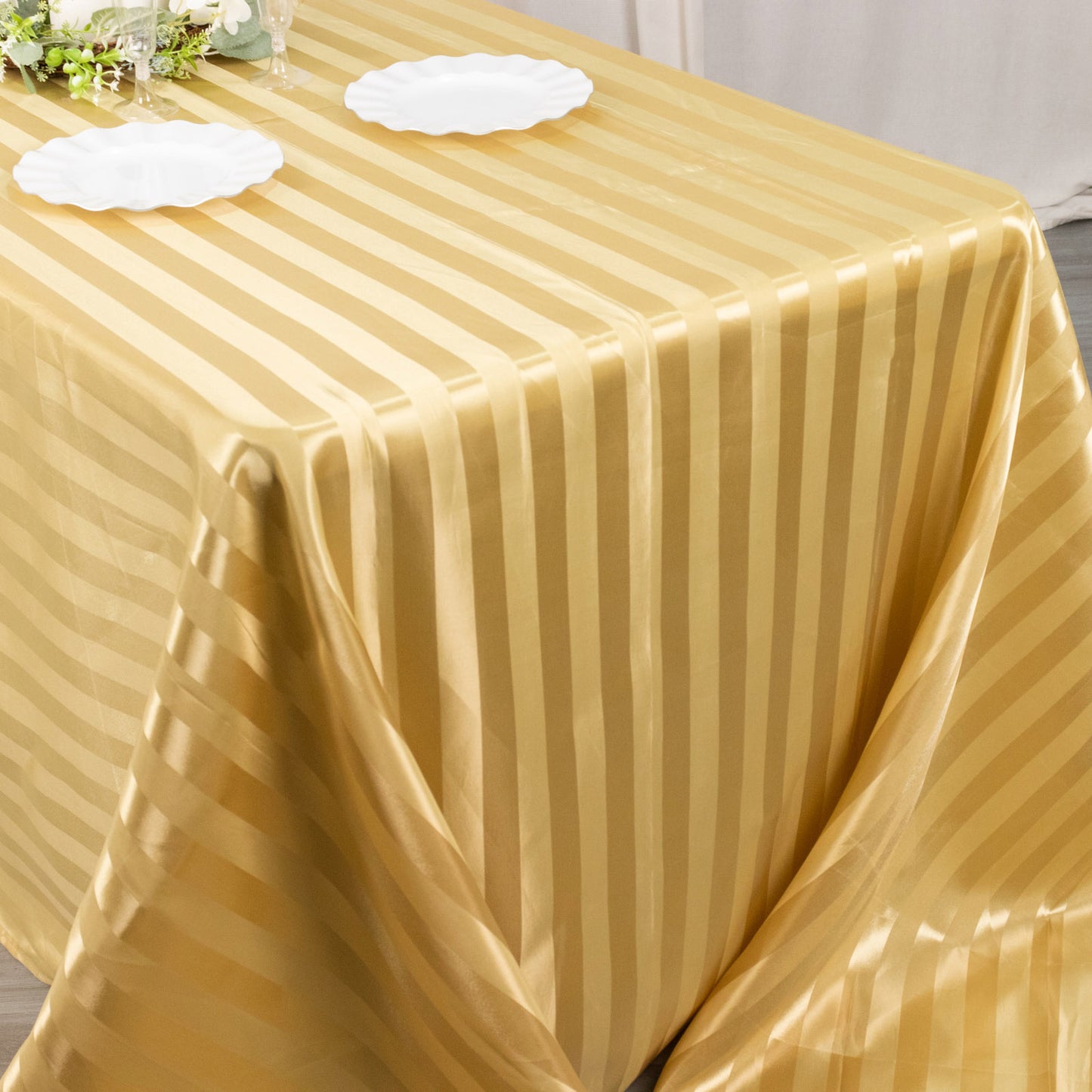 Champagne satin stripe rectangular tablecloth on a dining table.