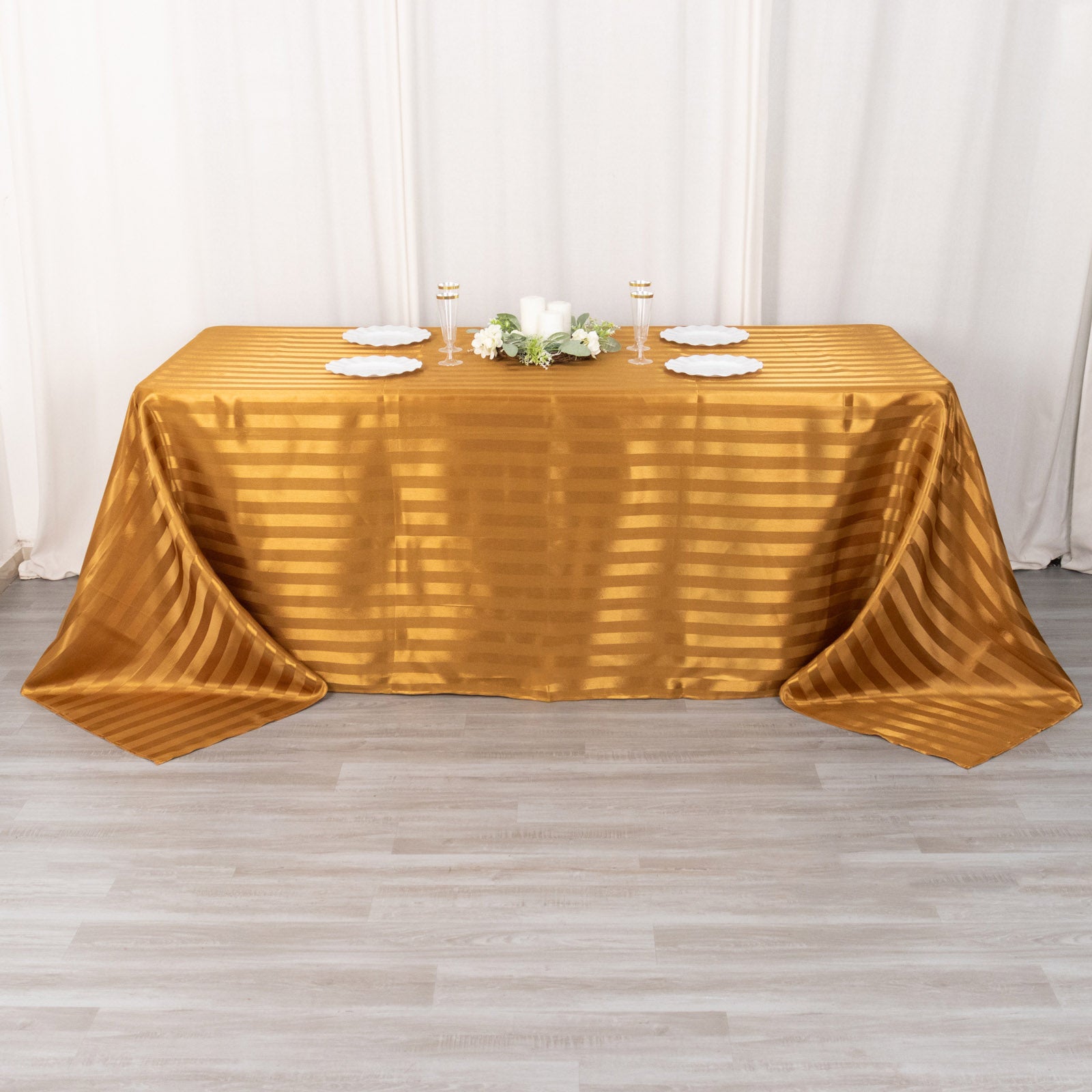 Gold satin stripe rectangular tablecloth on a table.