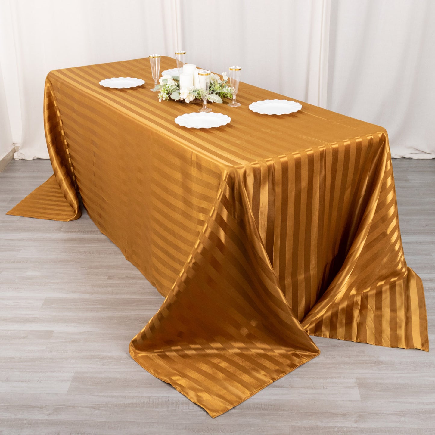 Gold satin stripe tablecloth on a rectangular table.