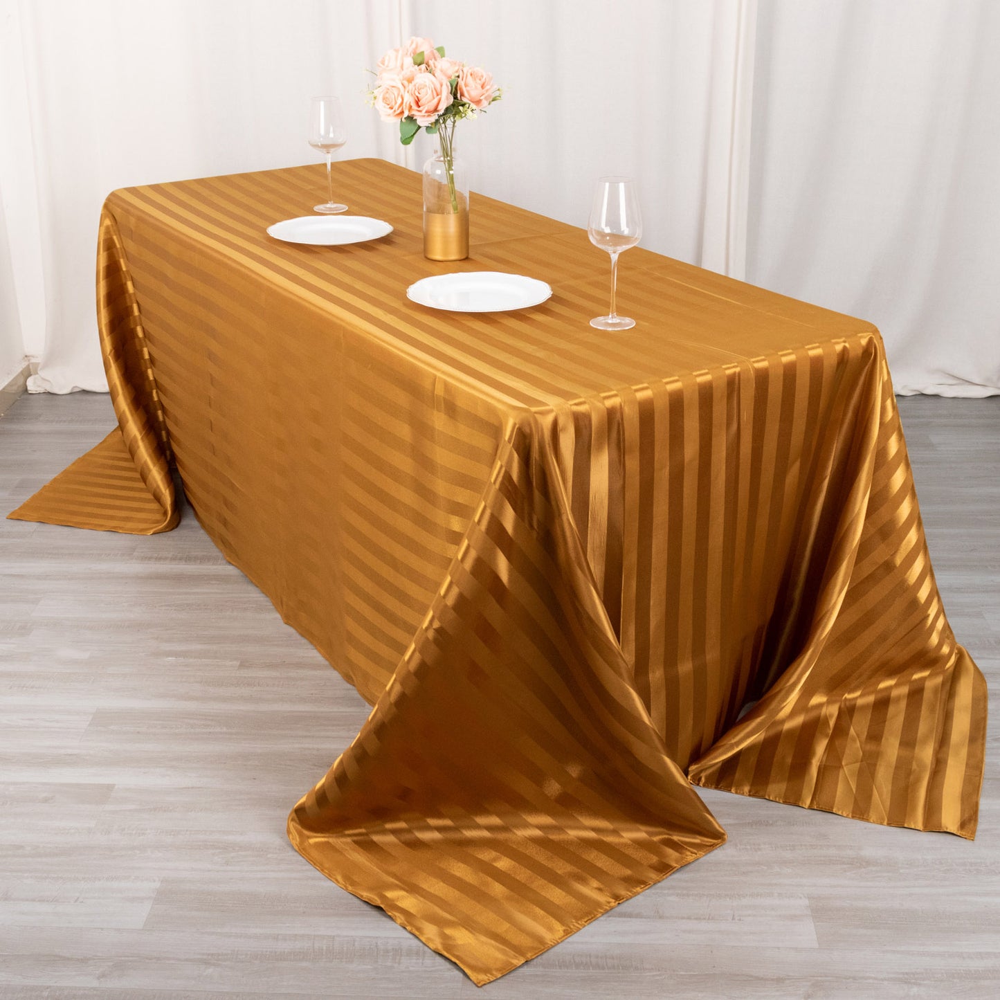 Gold satin stripe tablecloth on a rectangular table.