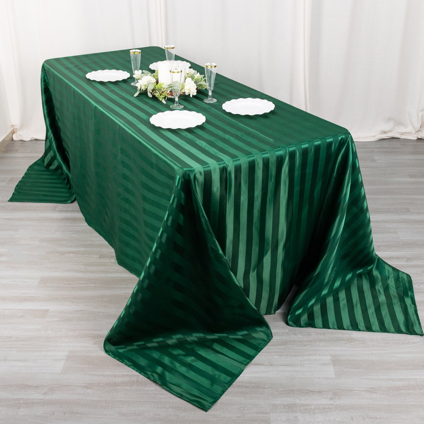 Hunter emerald green satin stripe tablecloth on a dining table.