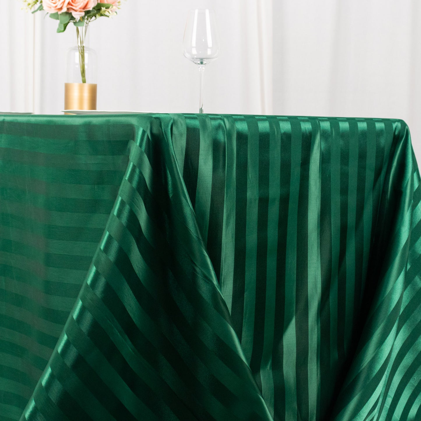 Hunter emerald green satin stripe tablecloth on a rectangular table.