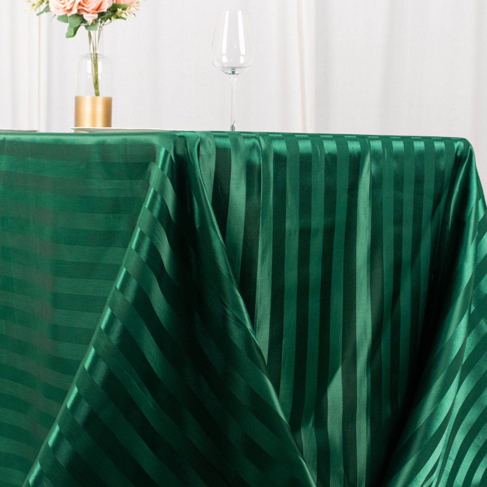 Hunter emerald green satin stripe tablecloth on a rectangular table.