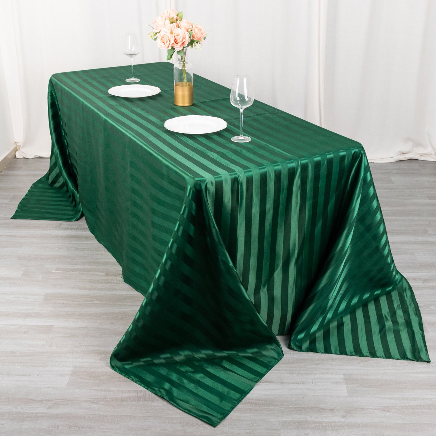 90"x132" Hunter Emerald Green Satin Stripe Tablecloth on a dining table.