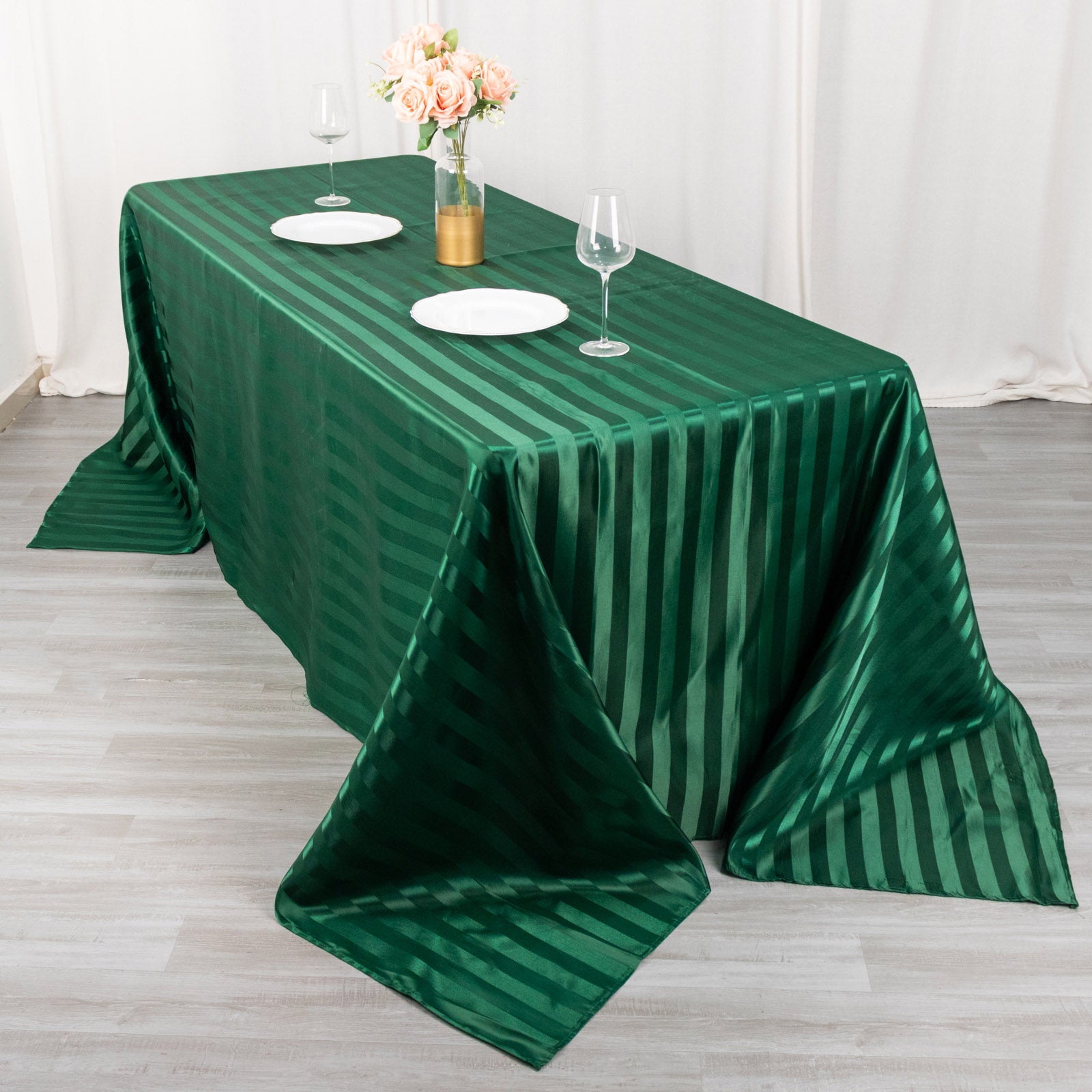 90"x132" Hunter Emerald Green Satin Stripe Tablecloth on a dining table.