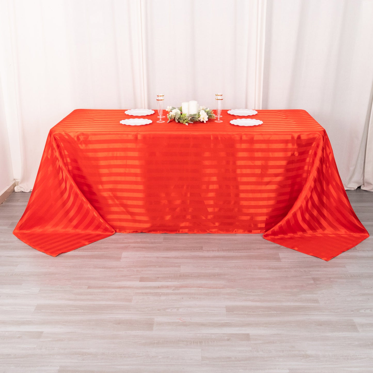 Red satin stripe seamless rectangular tablecloth on a table.