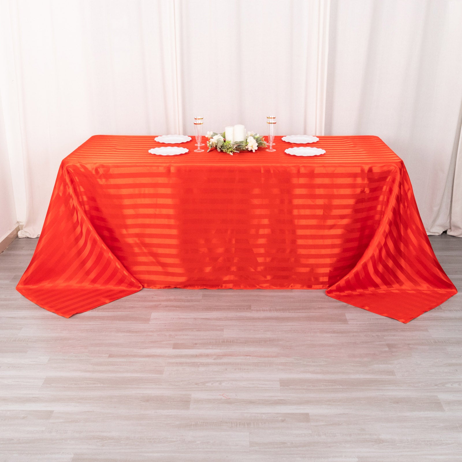 Red satin stripe seamless rectangular tablecloth on a table.