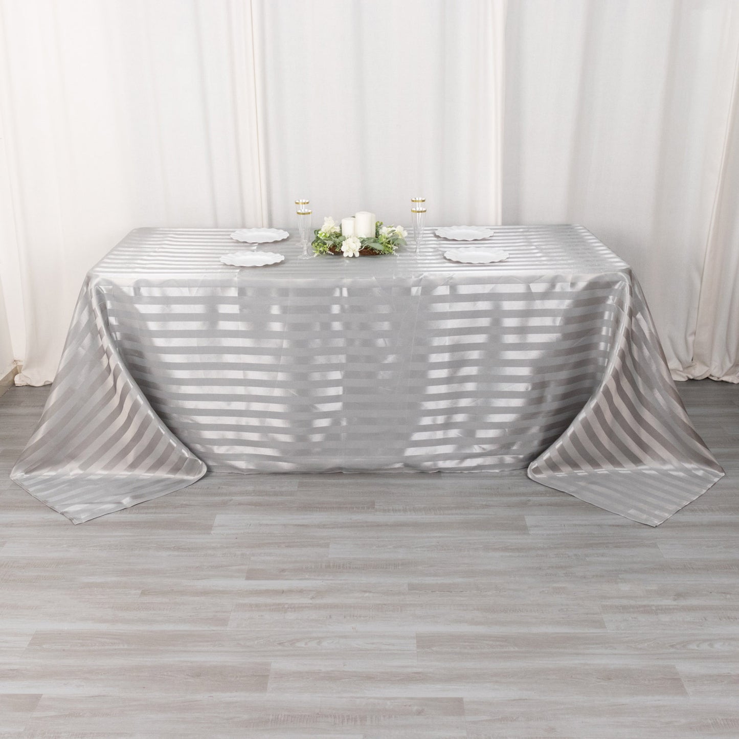 Silver satin stripe rectangular tablecloth on a dining table.