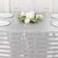 Silver satin stripe tablecloth on a dining table with decor.
