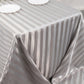 Silver satin stripe tablecloth on a rectangular table.