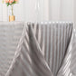 Silver satin stripe rectangular tablecloth on a dining table.