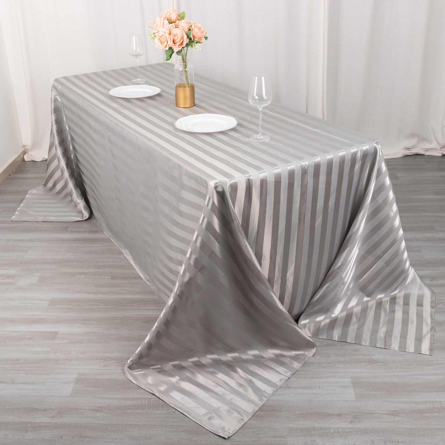 Silver satin stripe tablecloth on a rectangular table.