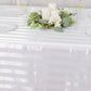 White satin stripe rectangular tablecloth on a decorated table.