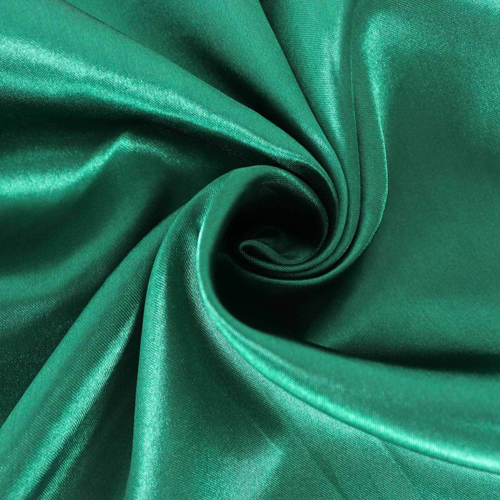 Emerald green seamless satin round tablecloth fabric close-up.