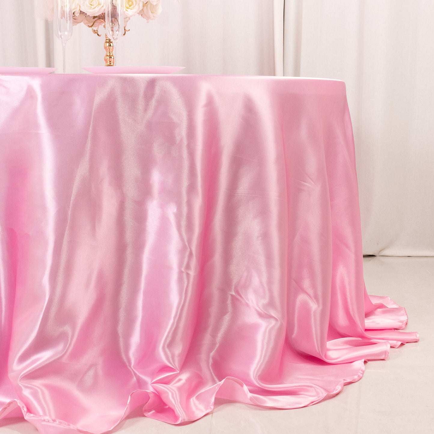 Pink satin round tablecloth for a 6-foot table with floor-length drop.