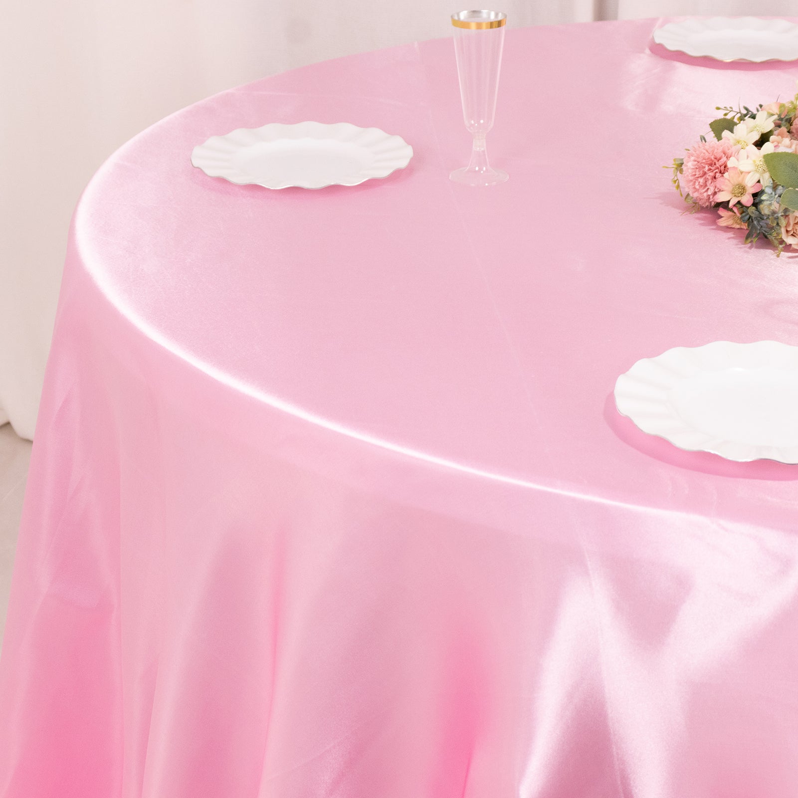 Pink satin round tablecloth for a 6-foot table with a floor-length drop.