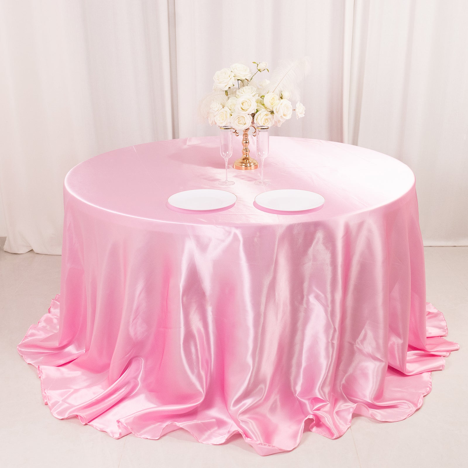 Pink satin round tablecloth for a 6-foot table with floor-length drop.