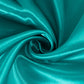 Turquoise satin round tablecloth for 6-foot table with floor-length drop.