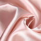 Dusty rose satin tablecloth fabric close-up.