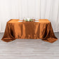 Cinnamon brown satin rectangular tablecloth on a dining table.