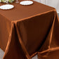 Cinnamon brown satin rectangular tablecloth on a dining table.
