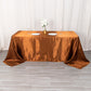 Cinnamon brown satin rectangular tablecloth on a table.