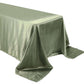Dusty sage green satin rectangular tablecloth on a table.