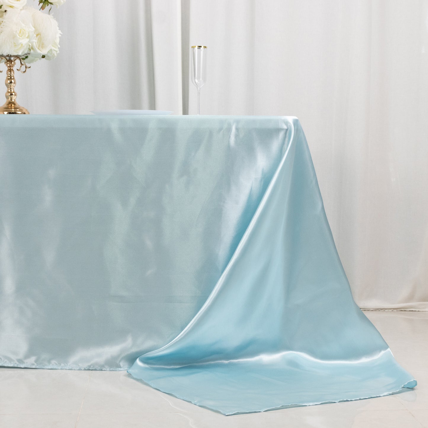 Light blue satin tablecloth draped elegantly over an 8-foot table.