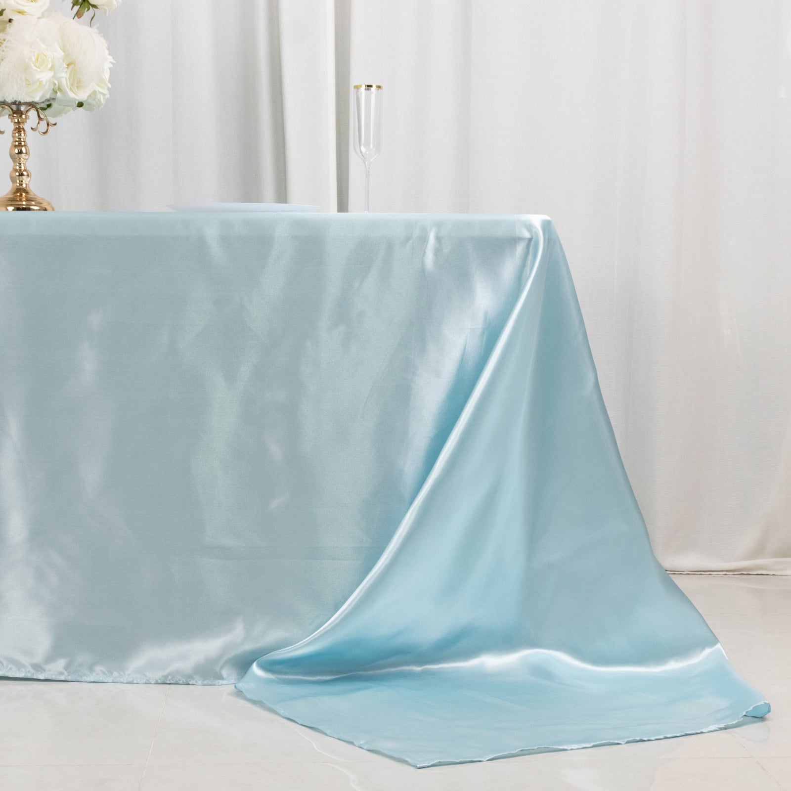 Light blue satin tablecloth draped elegantly over an 8-foot table.