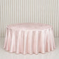 Blush round velvet tablecloth on a marble surface.