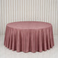 Dusty rose round velvet tablecloth on a marble surface.