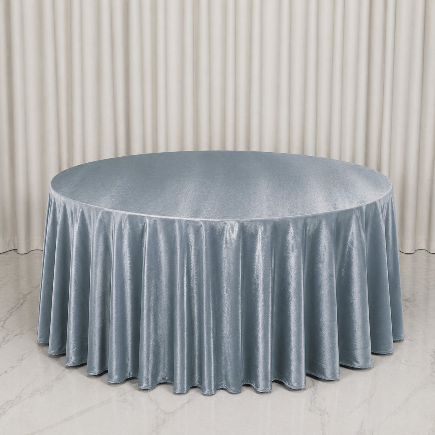 Dusty blue premium velvet round tablecloth on a marble surface.