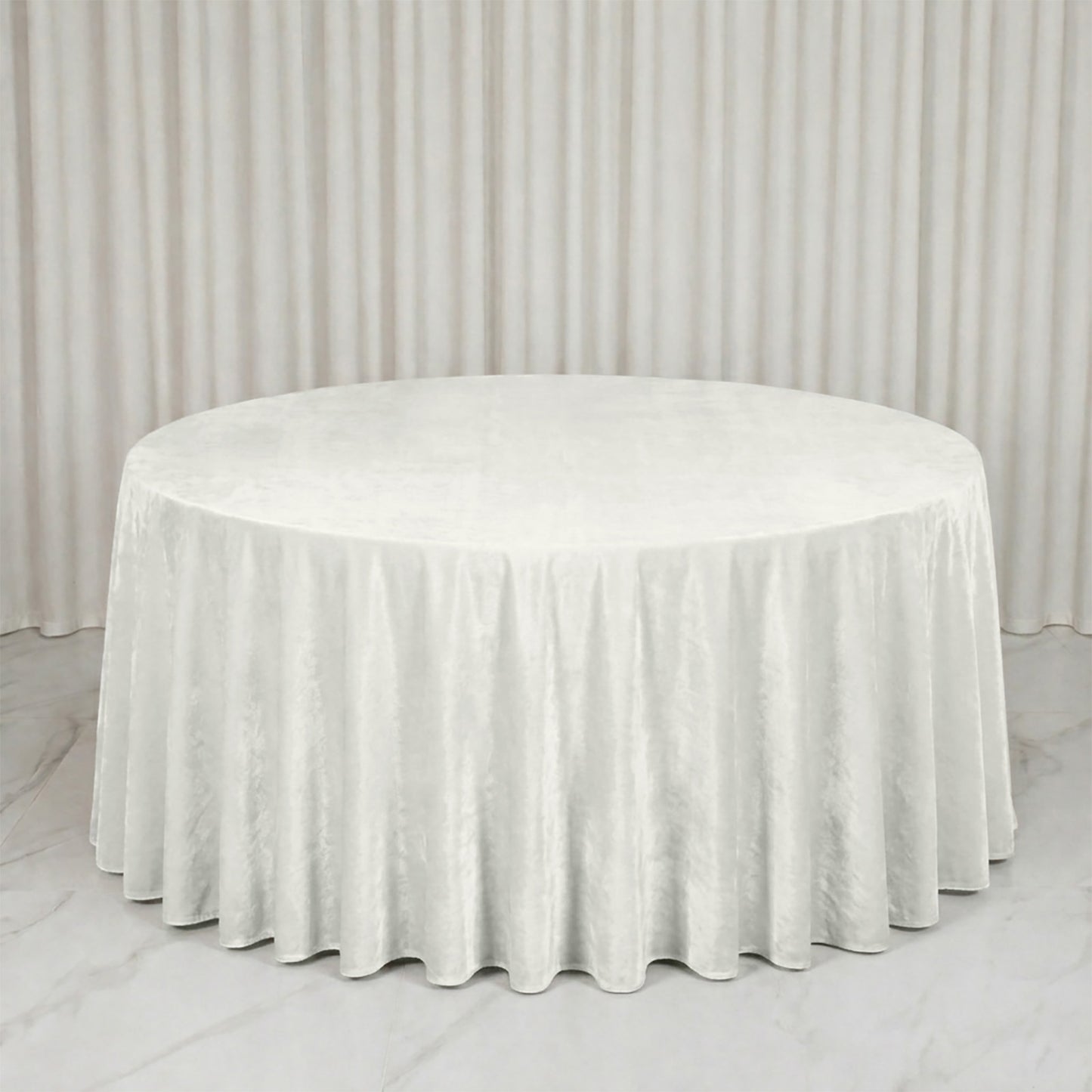 Premium Velvet 132" Round Tablecloth in Ivory, soft and seamless table cover.
