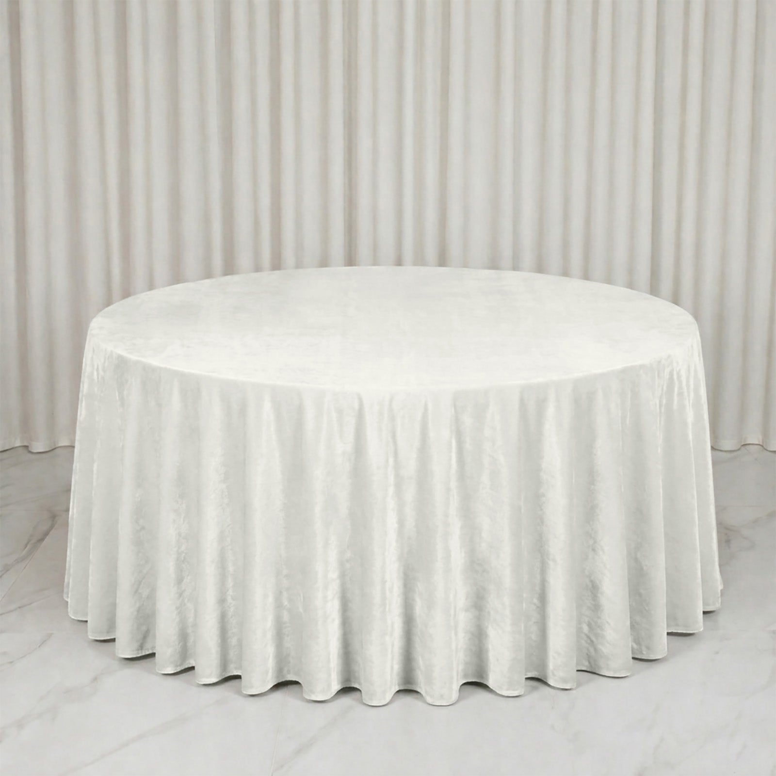 Premium Velvet 132" Round Tablecloth in Ivory, soft and seamless table cover.