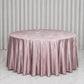 Mauve round tablecloth on a smooth surface with pleated edges.
