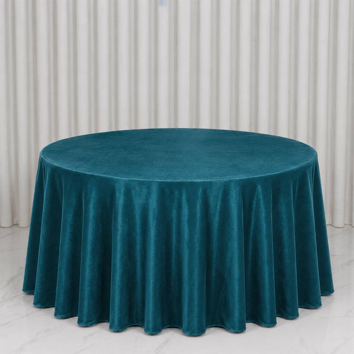 Premium velvet round tablecloth in peacock teal, soft and seamless for elegant dining.