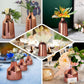 Rose gold mercury glass vases with floral arrangements.