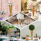 Brushed gold metal trumpet flower vase wedding centerpiece with floral arrangements.